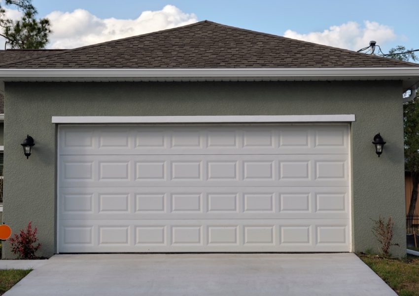 Wide garage double door and concrete driveway of new modern american house